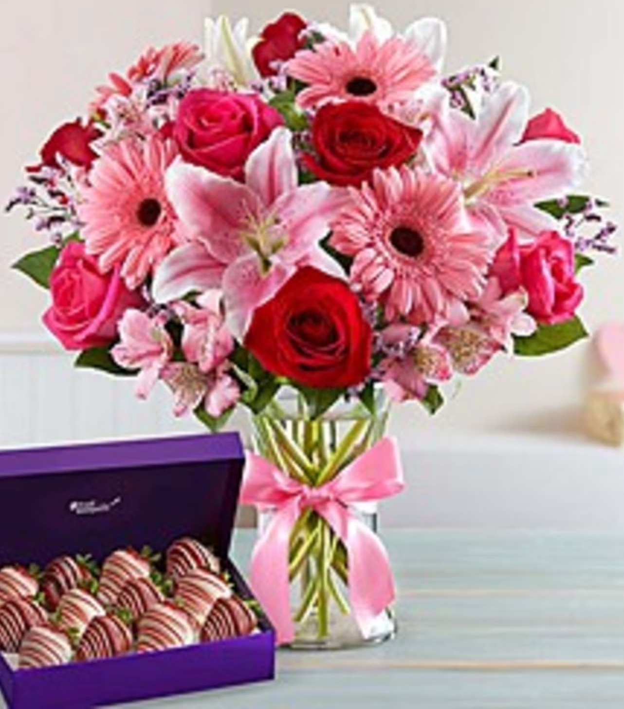 PINK PASSION Star gazer lilies, red roses, pink gerbera daisies ,hot pink roses and more with strawberries dipped in chocolate